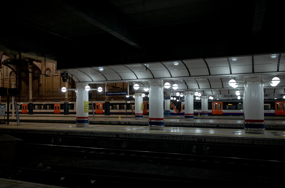 a train station with a train pulling into the station