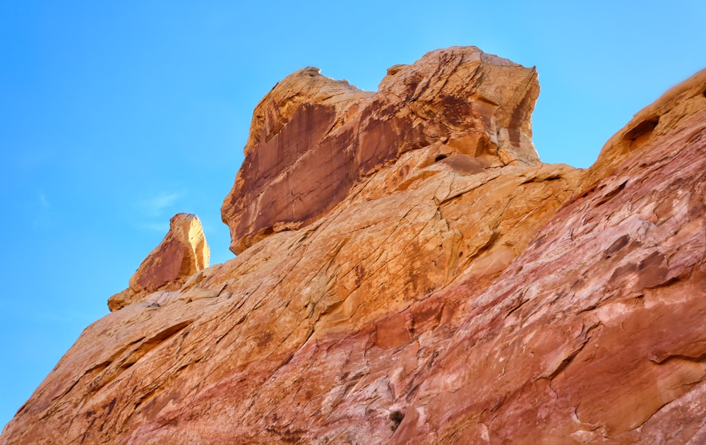 a rock formation with a statue of a person on top of it