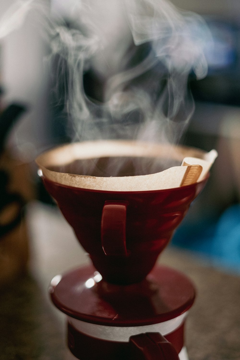 a steaming cup of coffee on a table