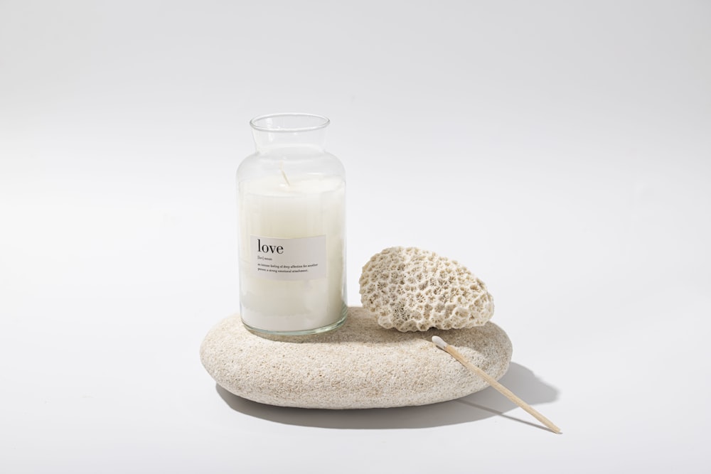 a candle and a sea sponge on a white background