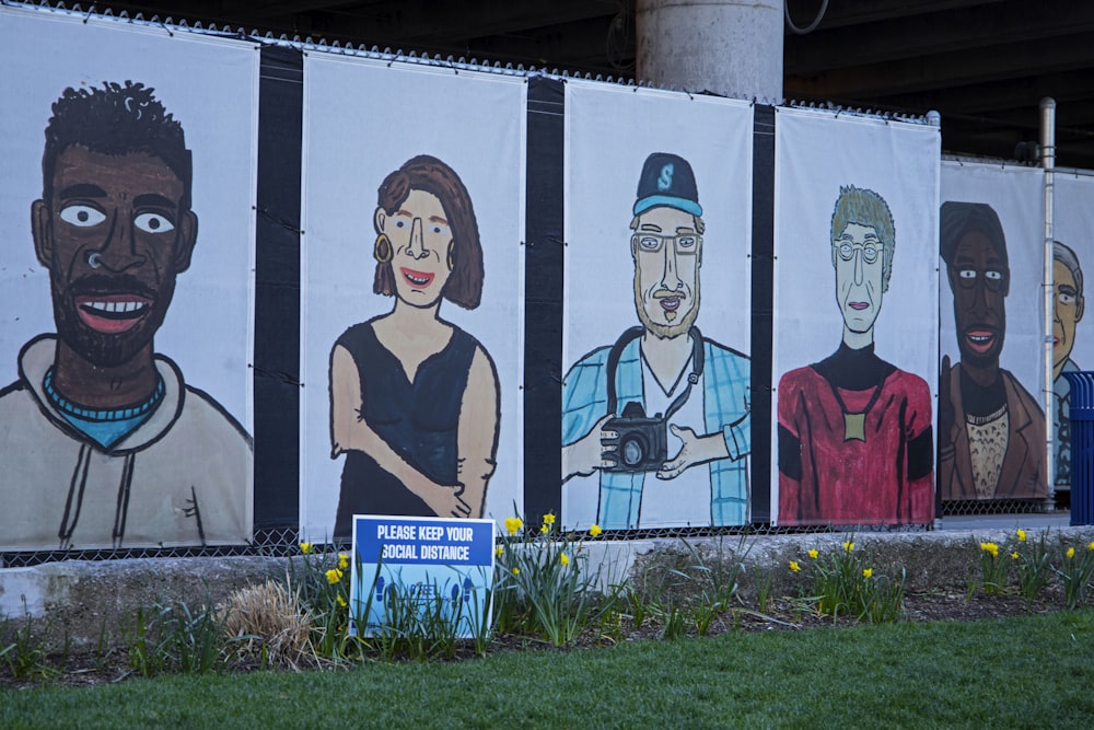 a wall with a bunch of pictures of people painted on it