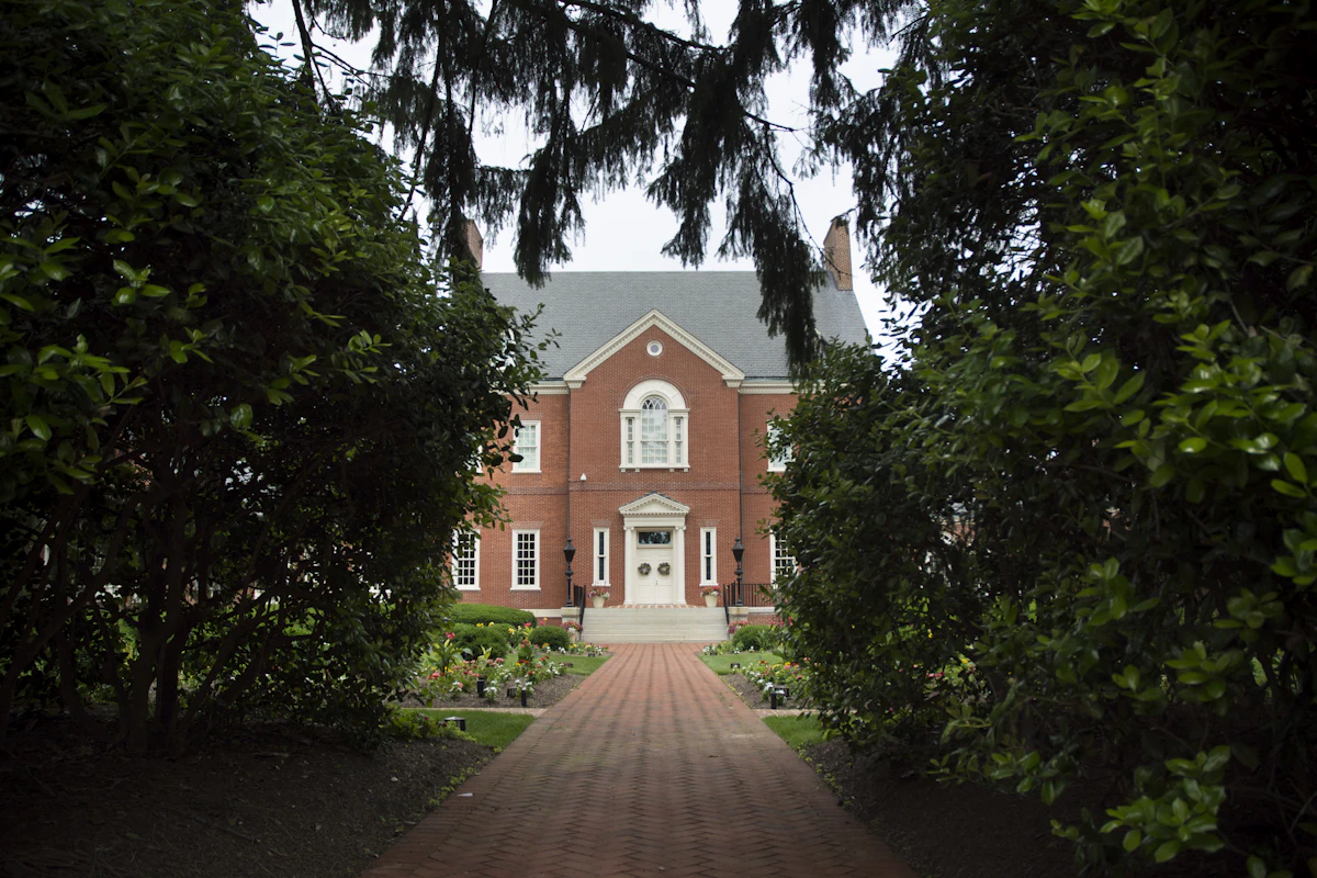 A stately red-brick Georgian estate home with white-columned entrance in Buckhead, GA.
