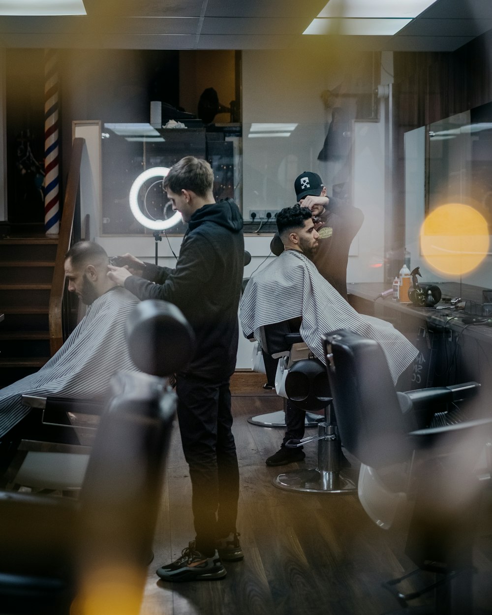 a man getting his hair cut at a barber shop