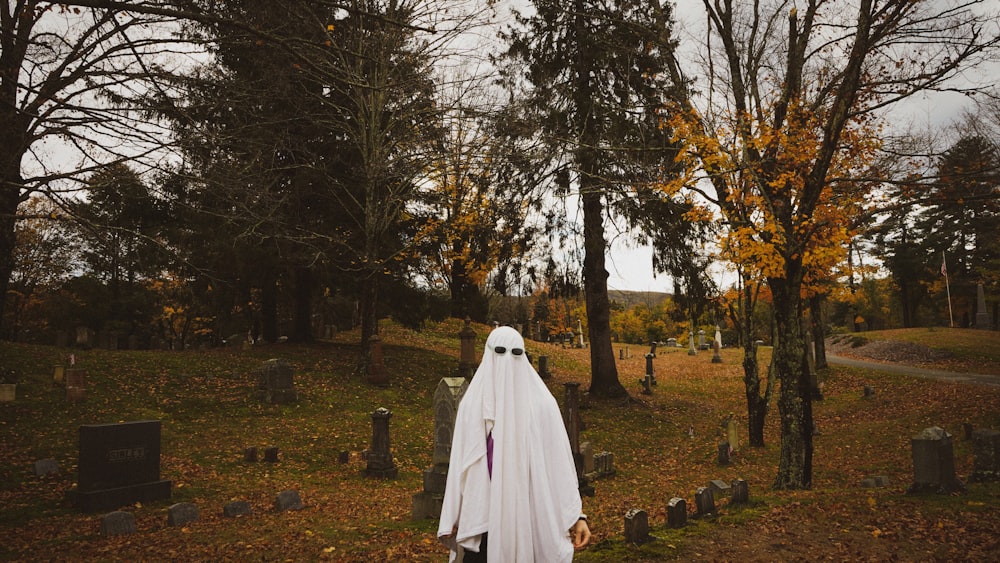a ghostly ghost in a graveyard with trees in the background