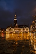a large building with a clock tower at night
