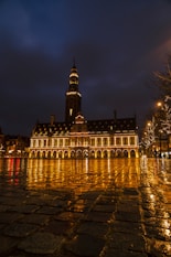 a large building with a clock tower at night