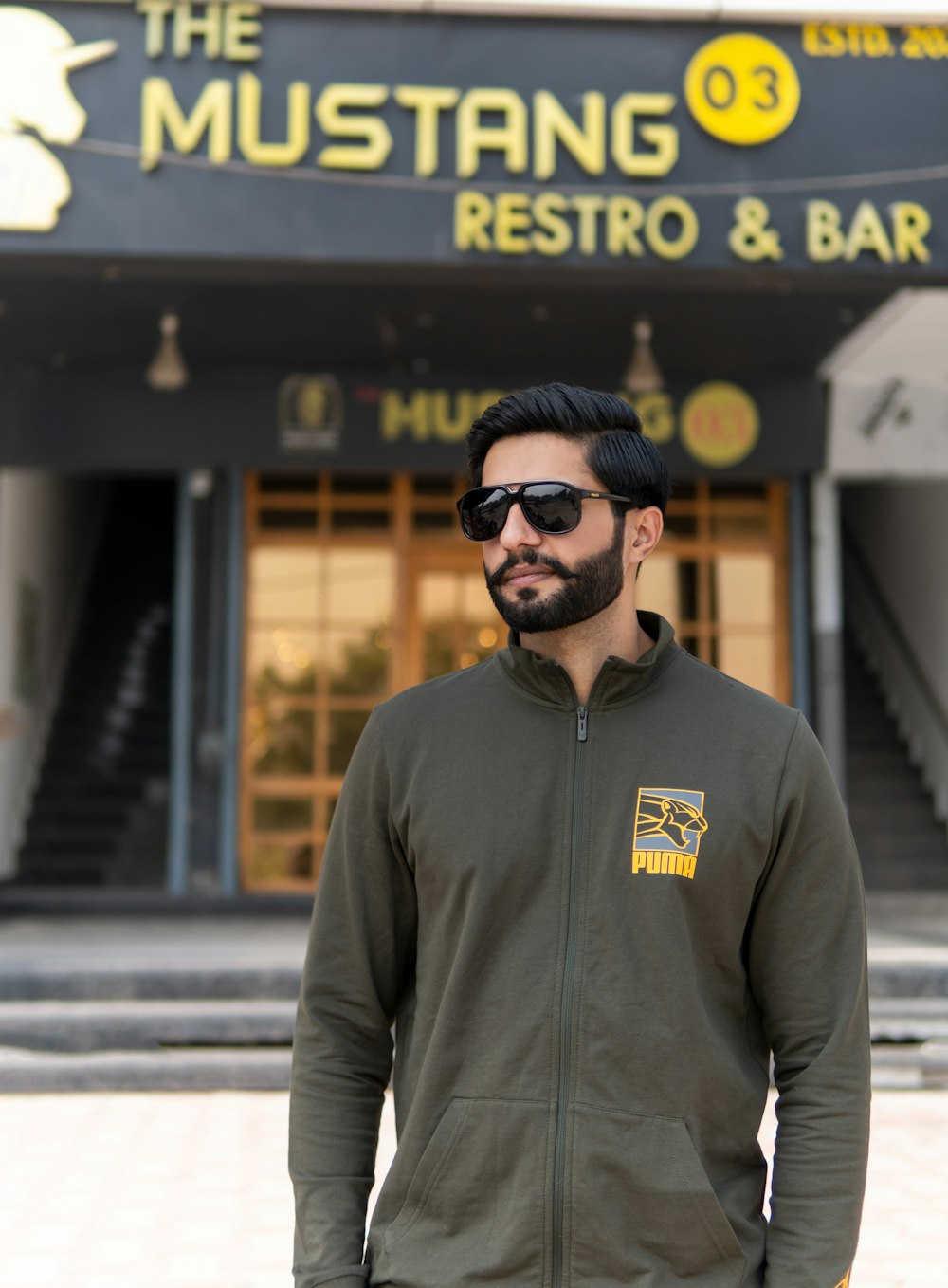 a man standing in front of a restaurant