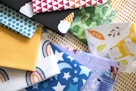 a pile of different colored fabrics on top of each other