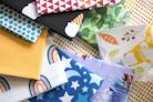 a pile of different colored fabrics on top of each other