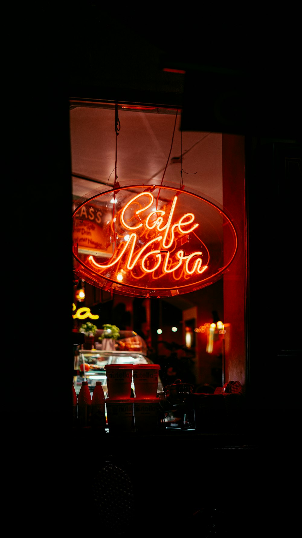 a neon sign hanging from the side of a building