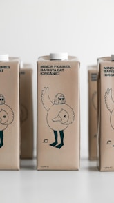 three cartons of milk sitting on a table
