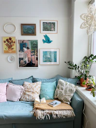 Cozy living room corner featuring a jute runner rug, ruffled linen curtains, and velvet throw pillows.