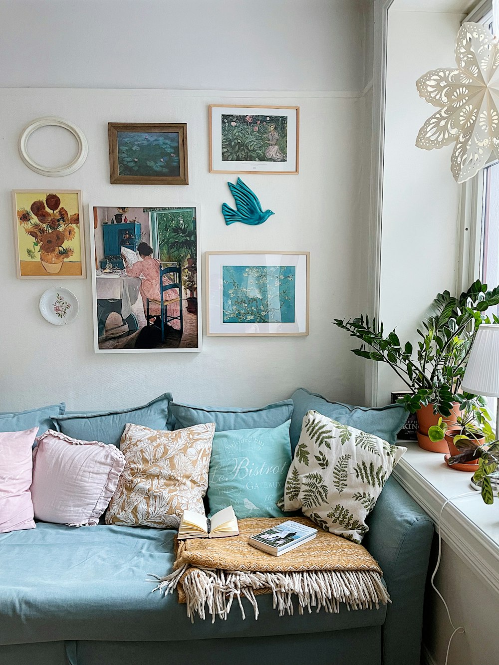 a living room filled with furniture and pictures on the wall