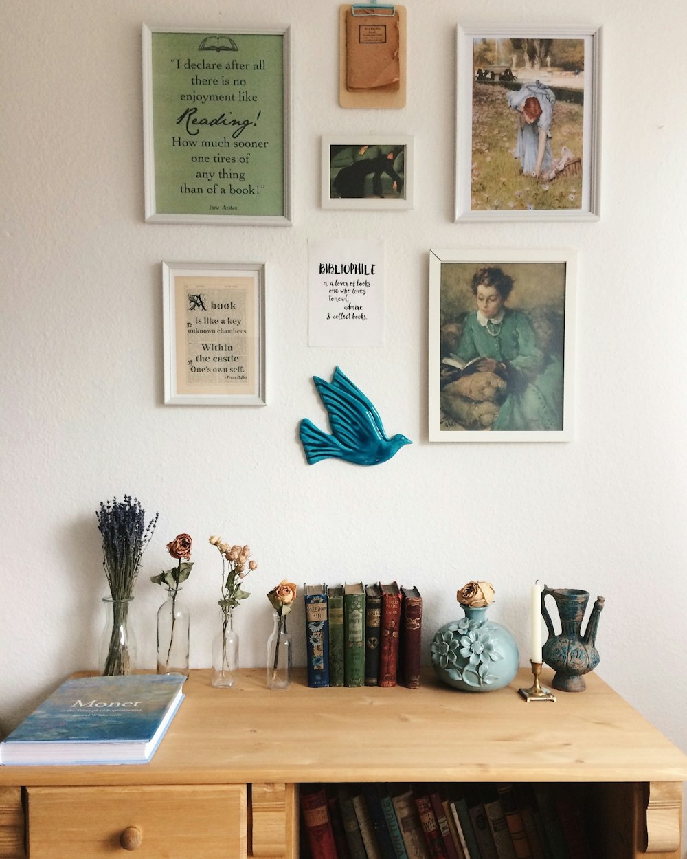 a wooden desk topped with lots of books