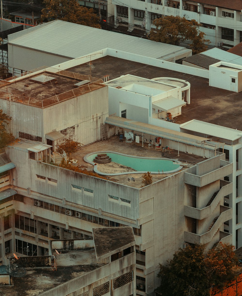 an aerial view of a building with a swimming pool
