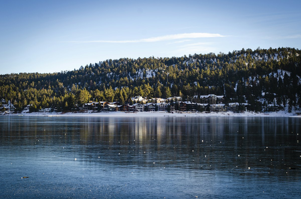Snowy pine shoreline on Big Bear Lake