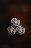 three metal buttons with a lion head on them