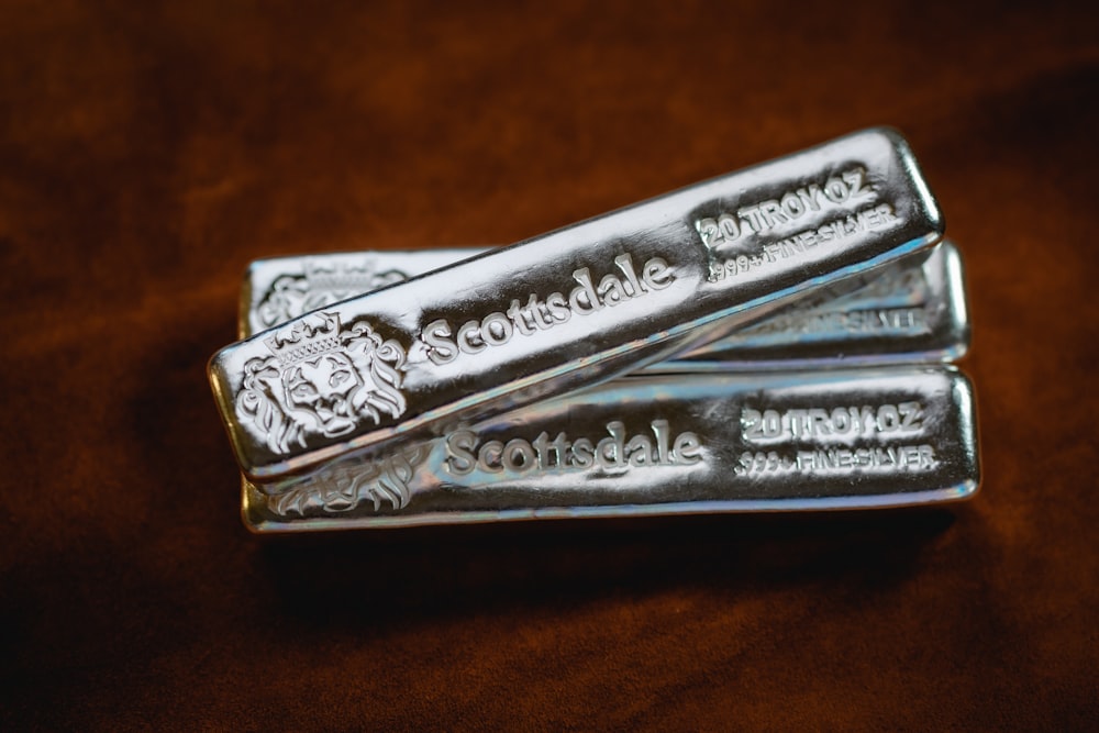 three silver bars sitting on top of a table