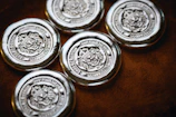 a group of four metal buttons sitting on top of a table