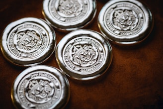a group of four metal buttons sitting on top of a table