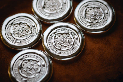 a group of four metal buttons sitting on top of a table
