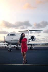A pilot in uniform confidently walking toward a private jet on tarmac.