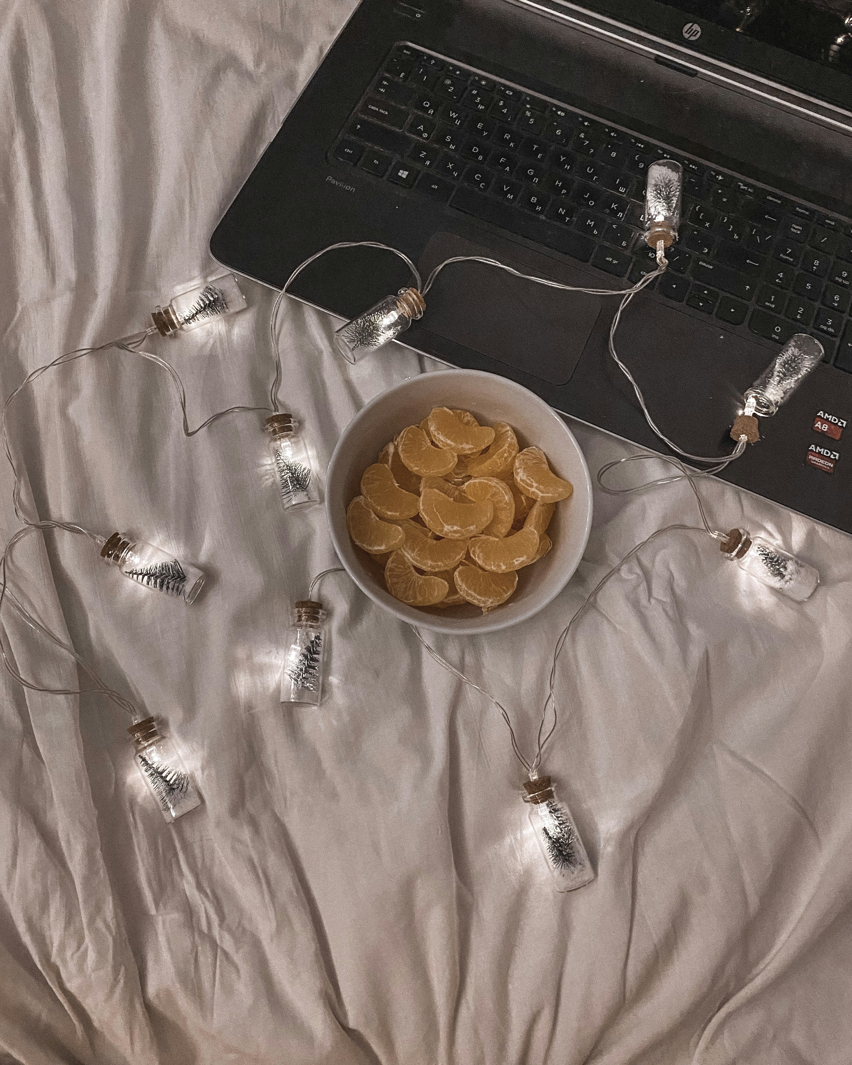 a bowl of chips sits in front of a laptop