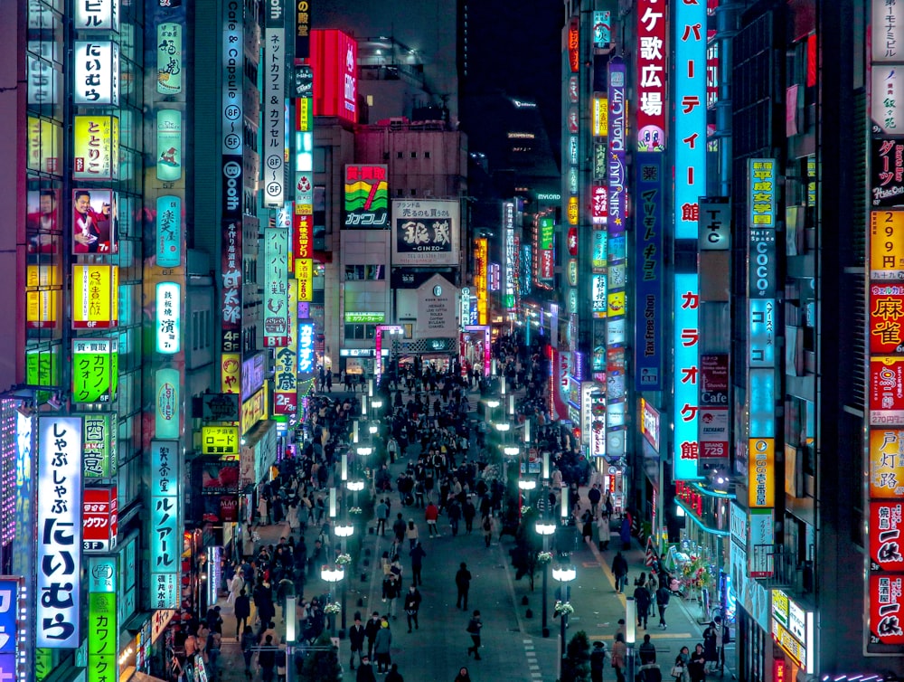 a city street filled with lots of neon signs