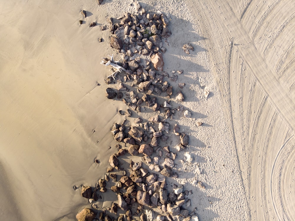 an aerial view of rocks and gravel on a beach