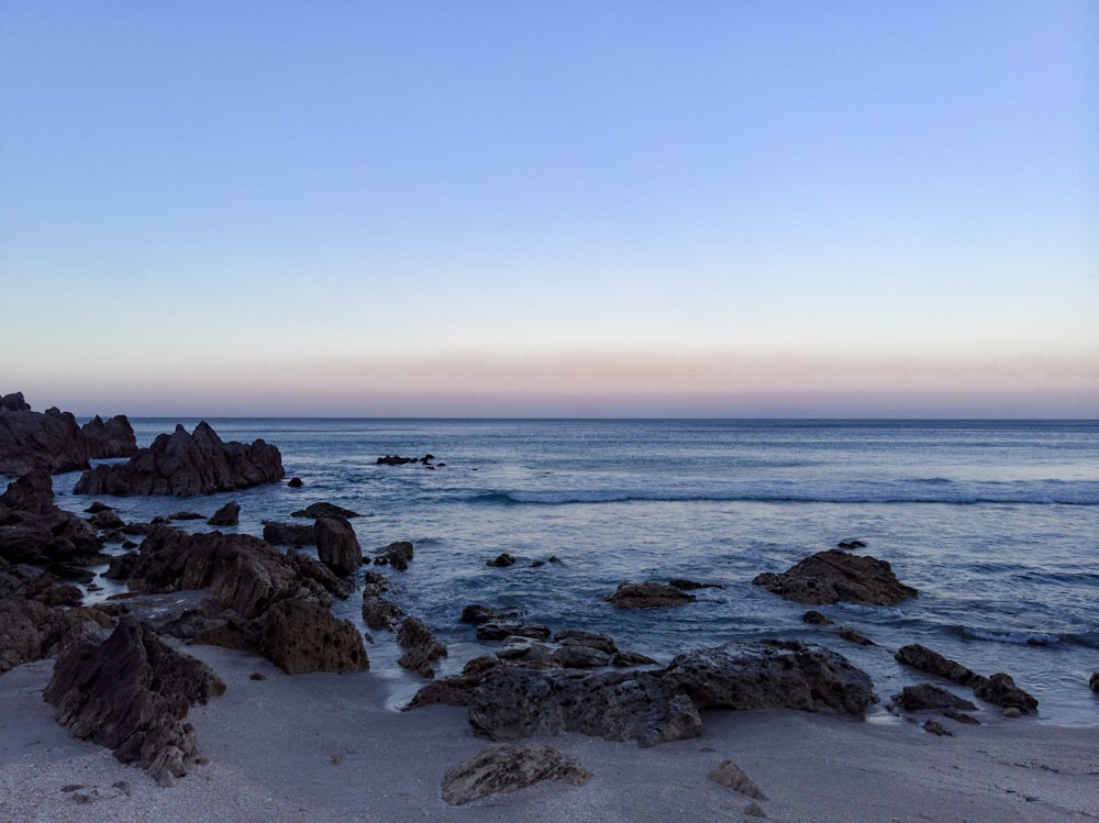 a view of the ocean from a rocky shore