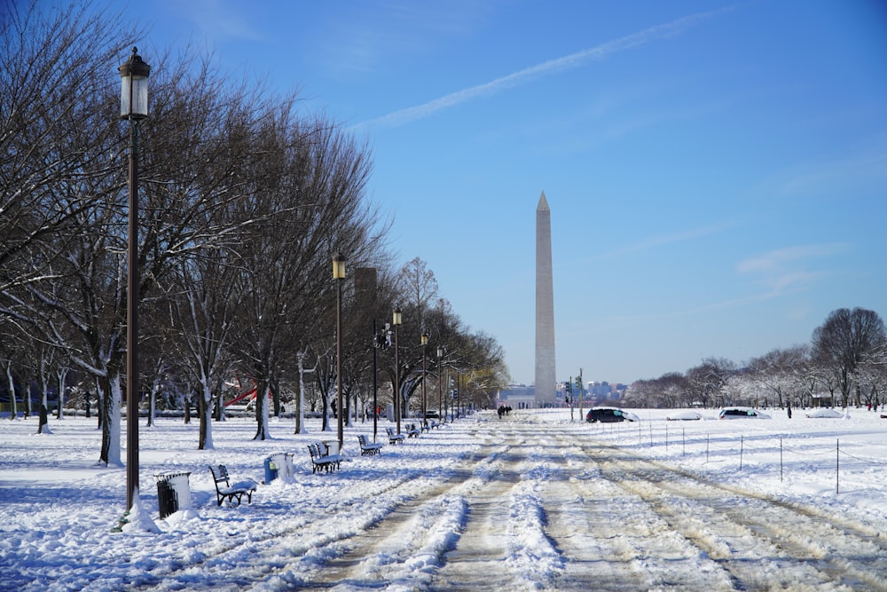 the washington monument is in the distance in the snow
