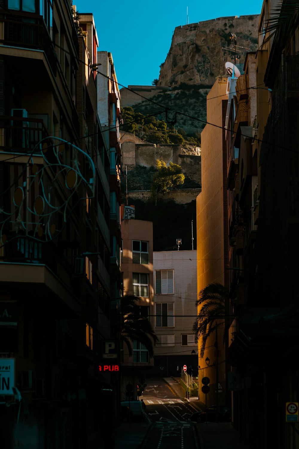 a city street with a mountain in the background