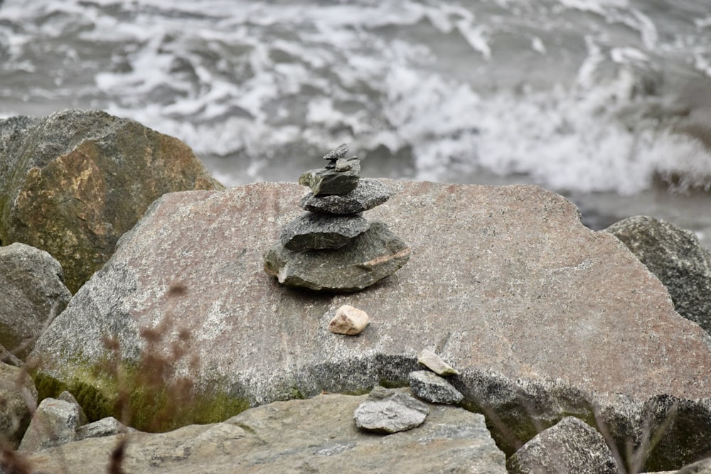 a pile of rocks sitting on top of a beach