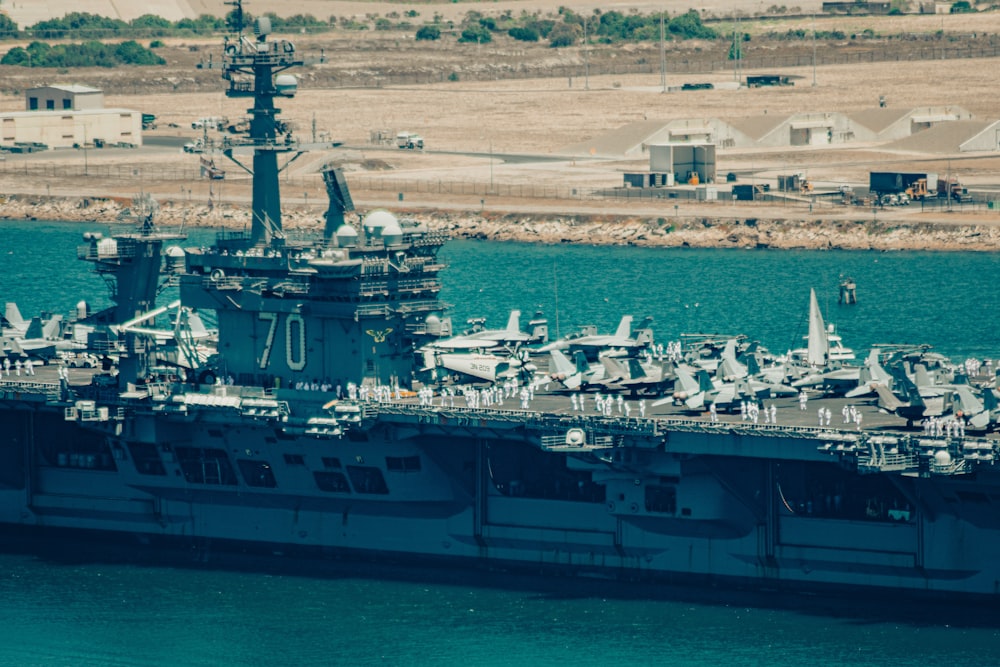 a large navy ship in a body of water