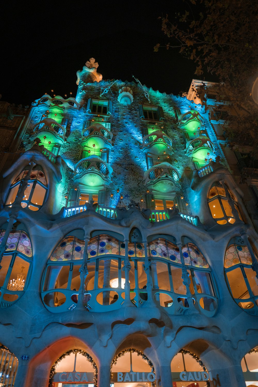 a tall building with lots of windows lit up at night