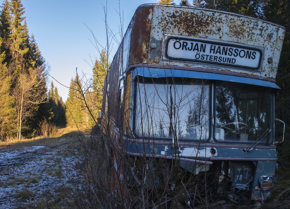 an old abandoned bus sitting in a field