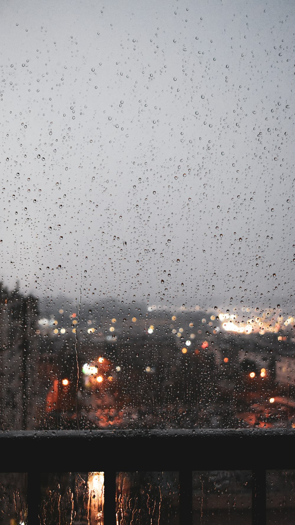 a view of a city through a rain covered window