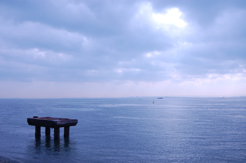 a large body of water with a boat in the distance