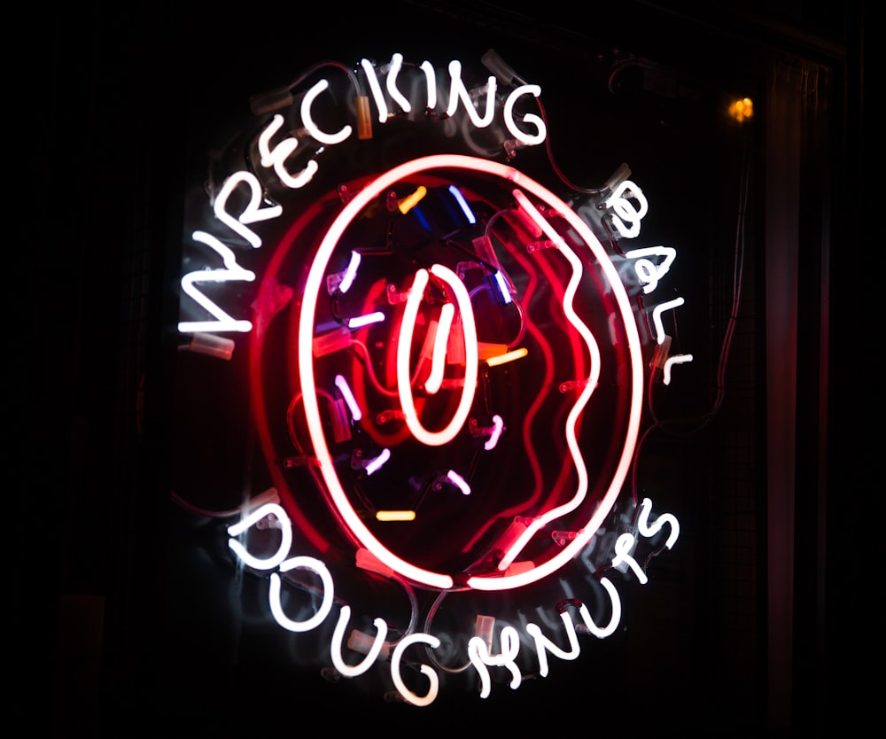 a neon sign that says wreck doughnuts
