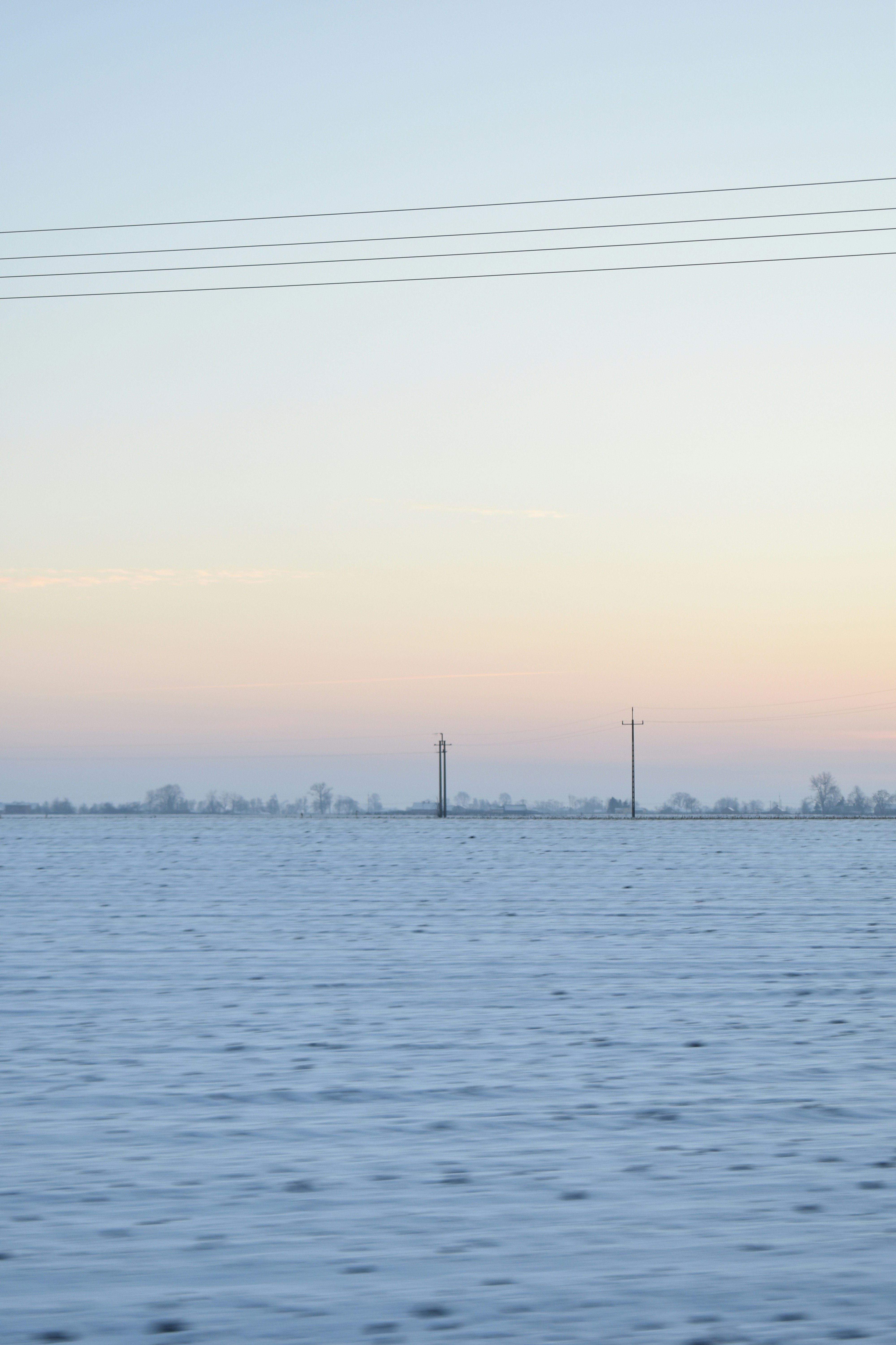 a large body of water with power lines above it