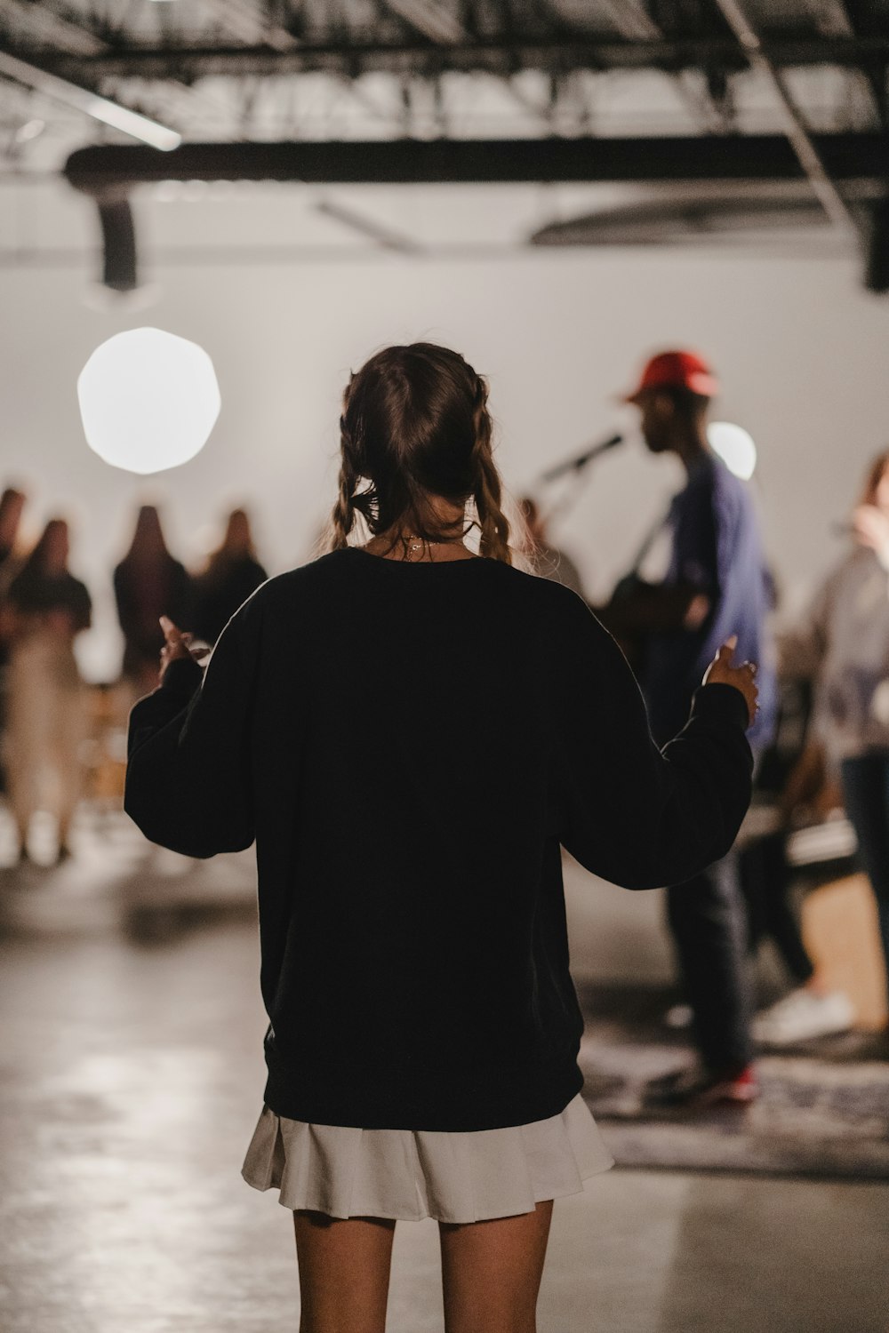 a woman standing in a room with a group of people