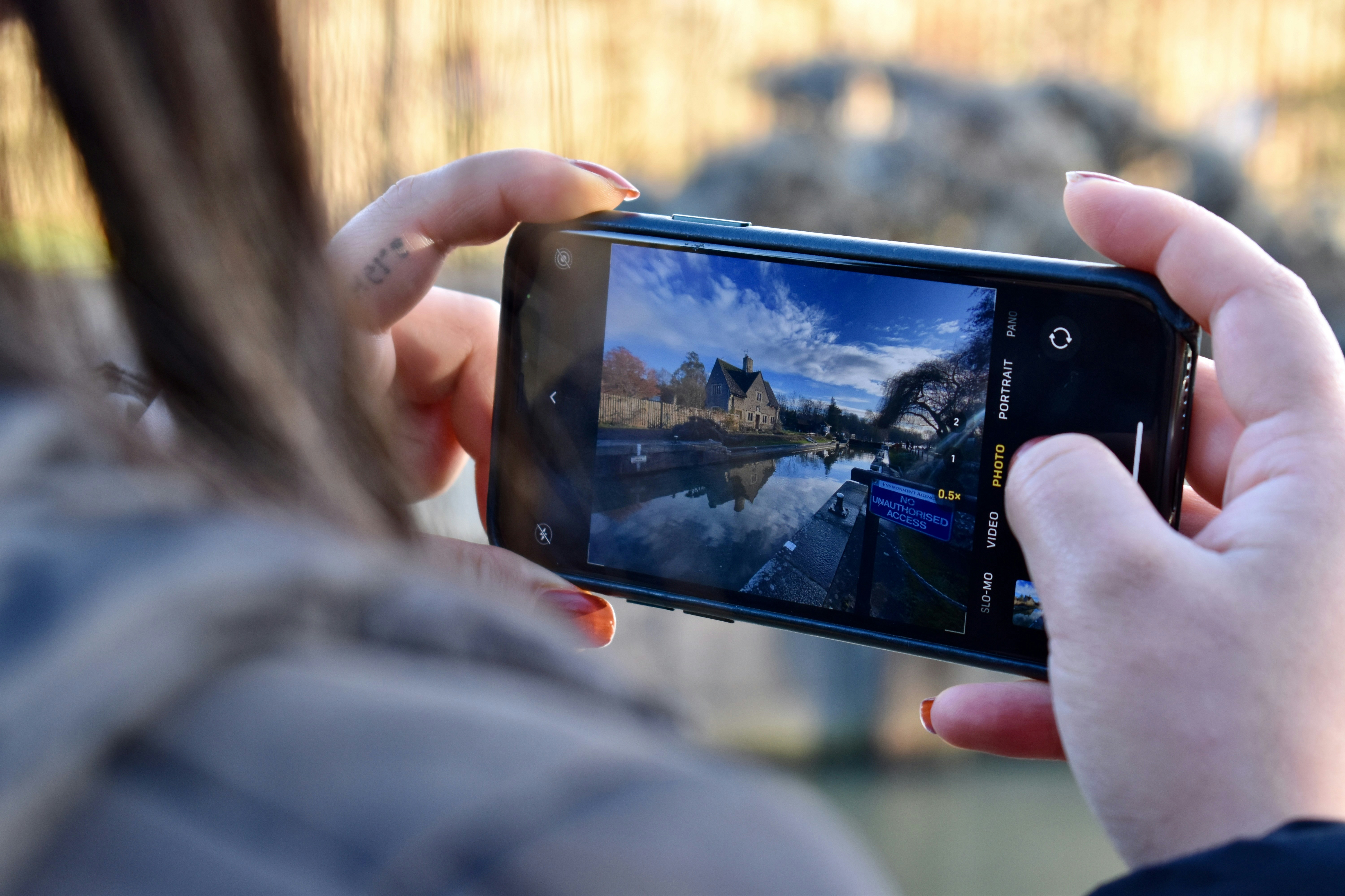 a person taking a picture with a cell phone
