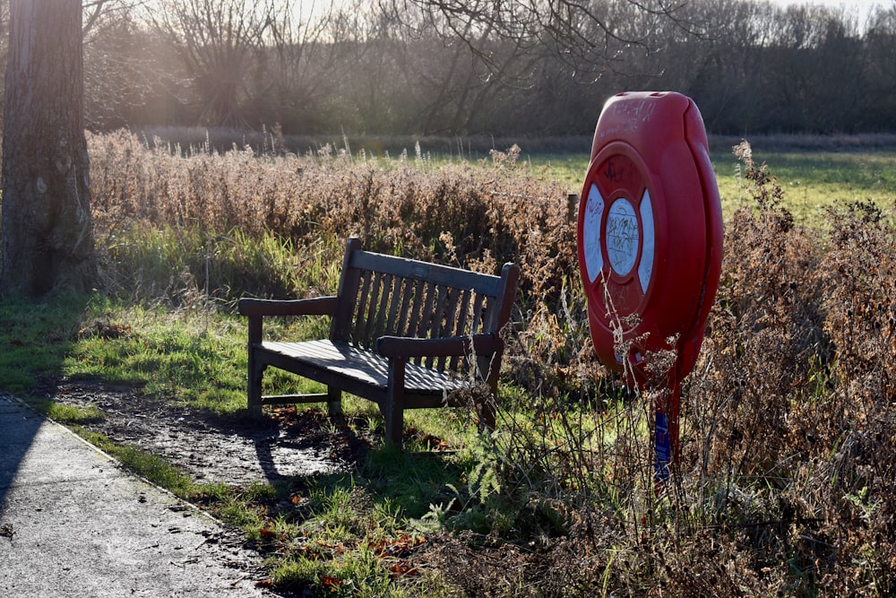 a park bench next to a fire hydrant in a field