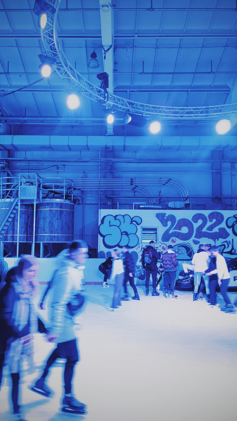 a group of people skating on an ice rink