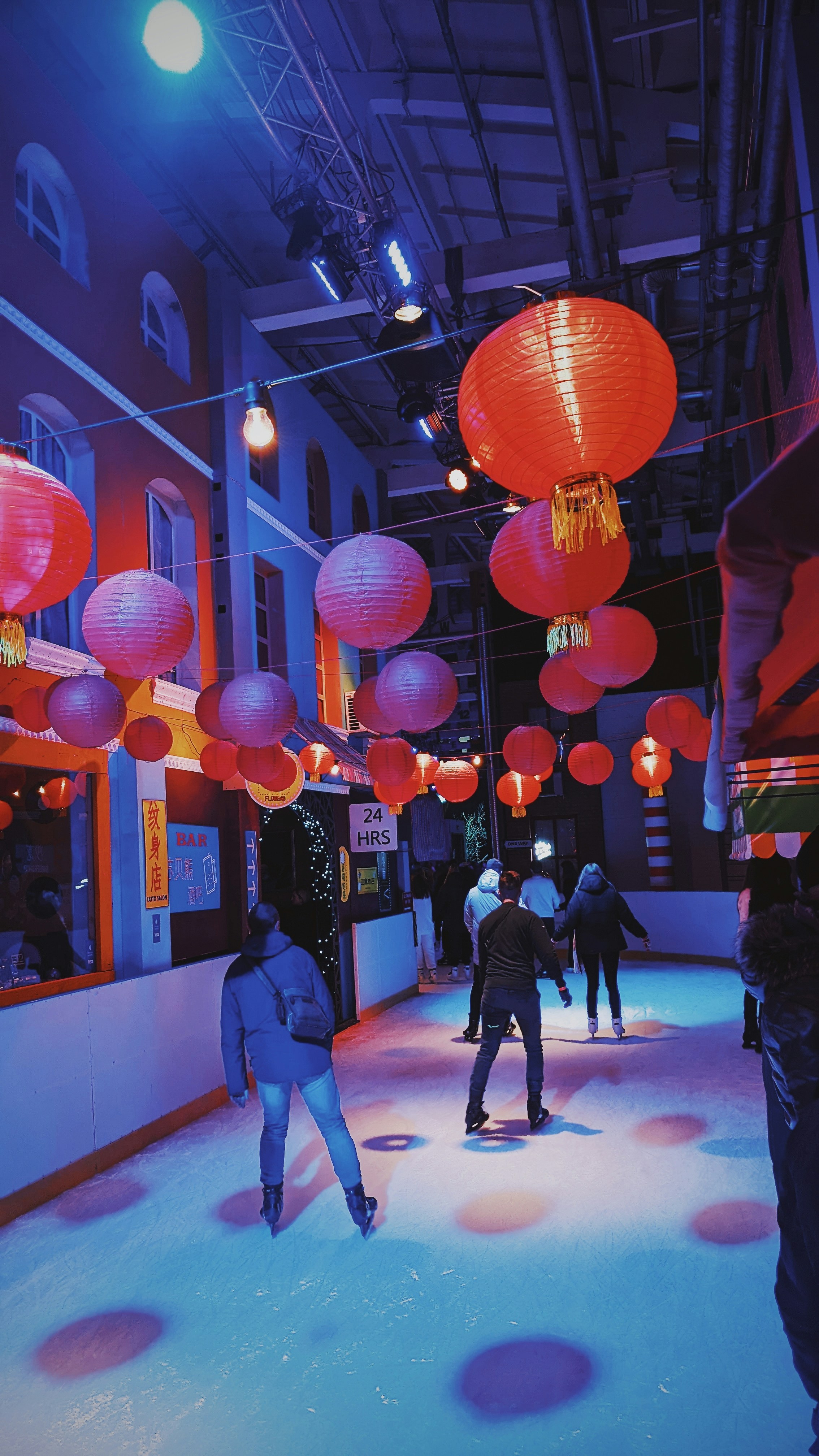 a group of people skating on an ice rink
