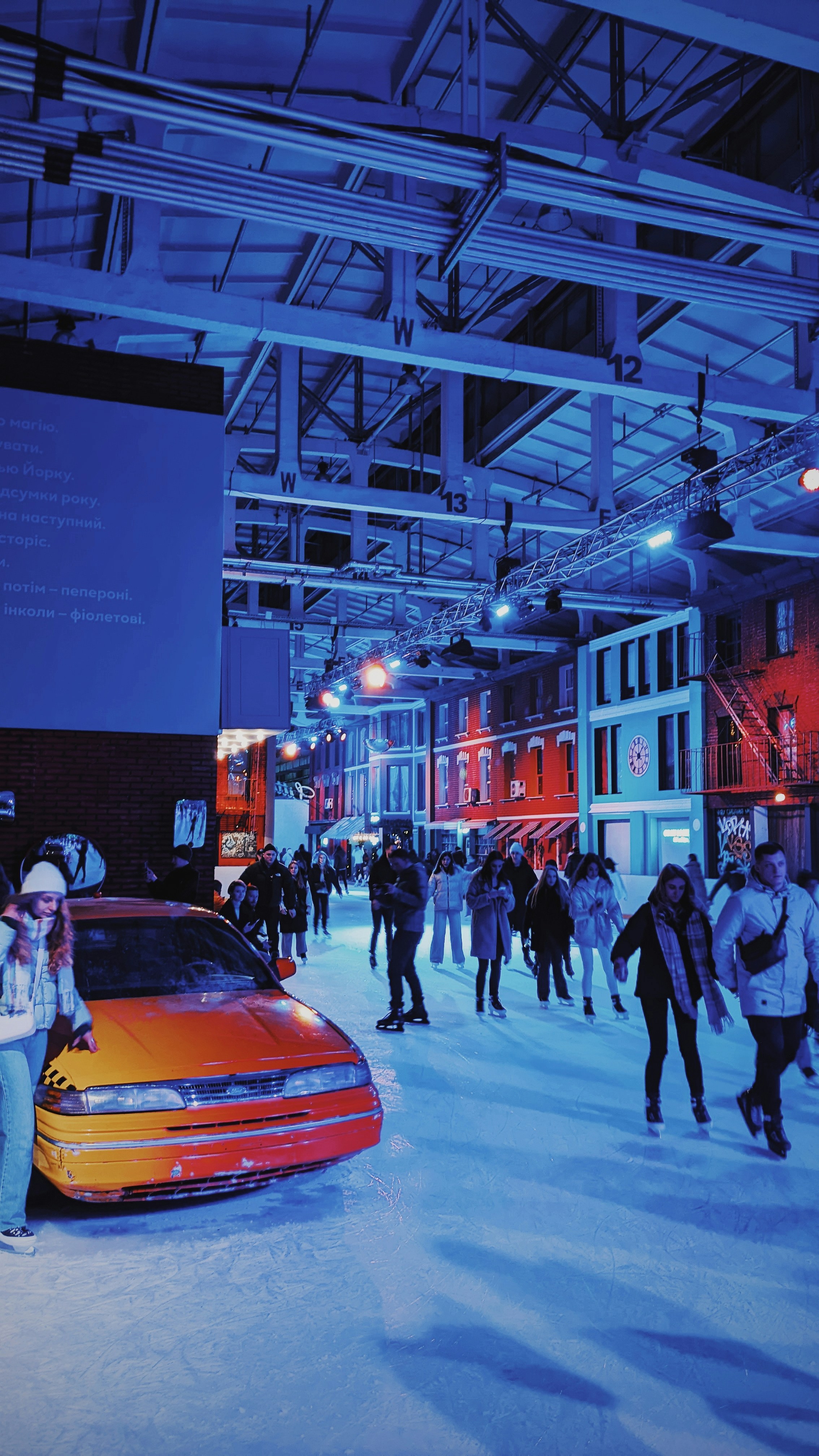 a group of people standing around a car in the snow