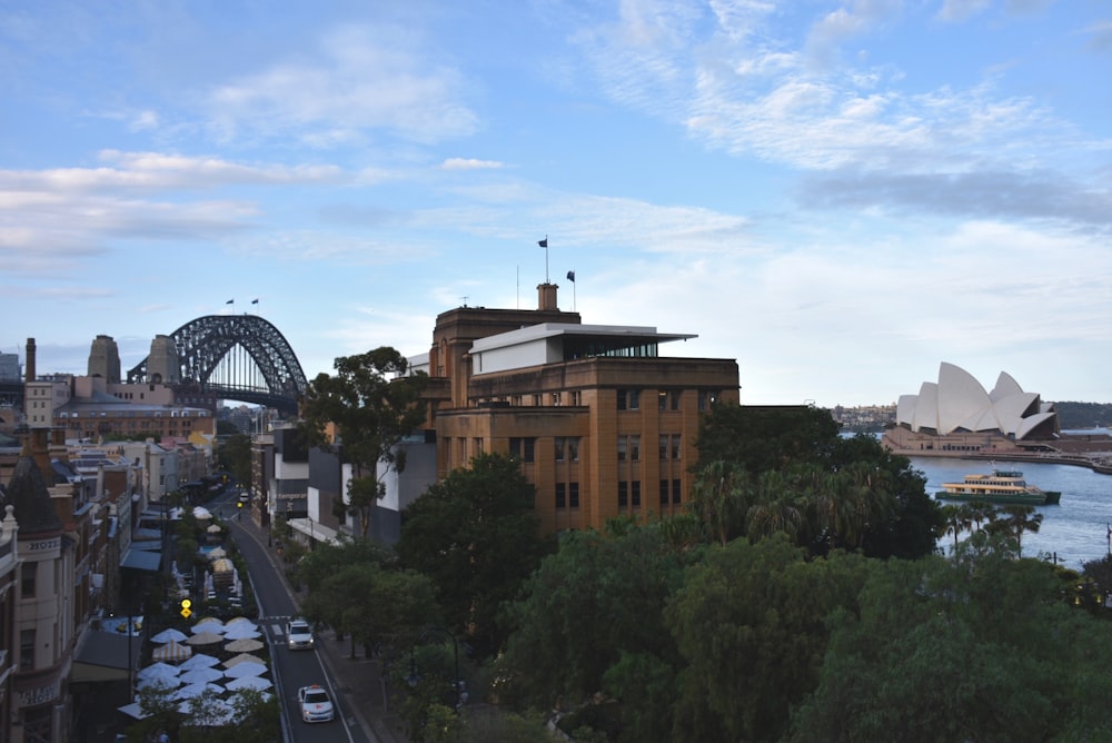 an aerial view of a city with a bridge in the background