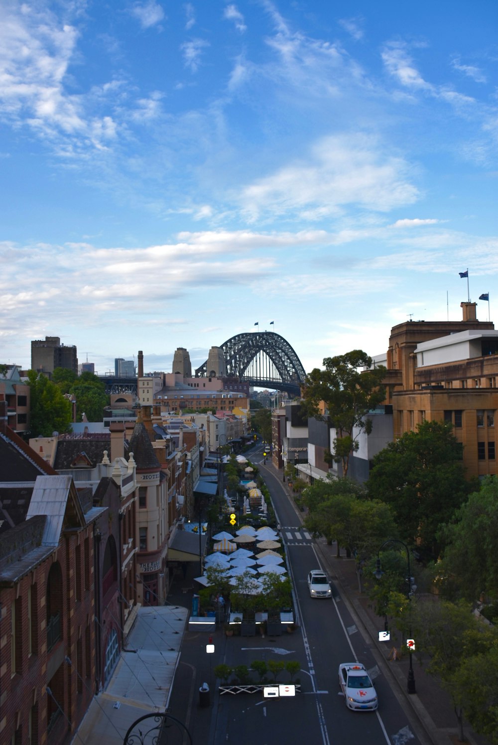 a city street with a bridge in the background