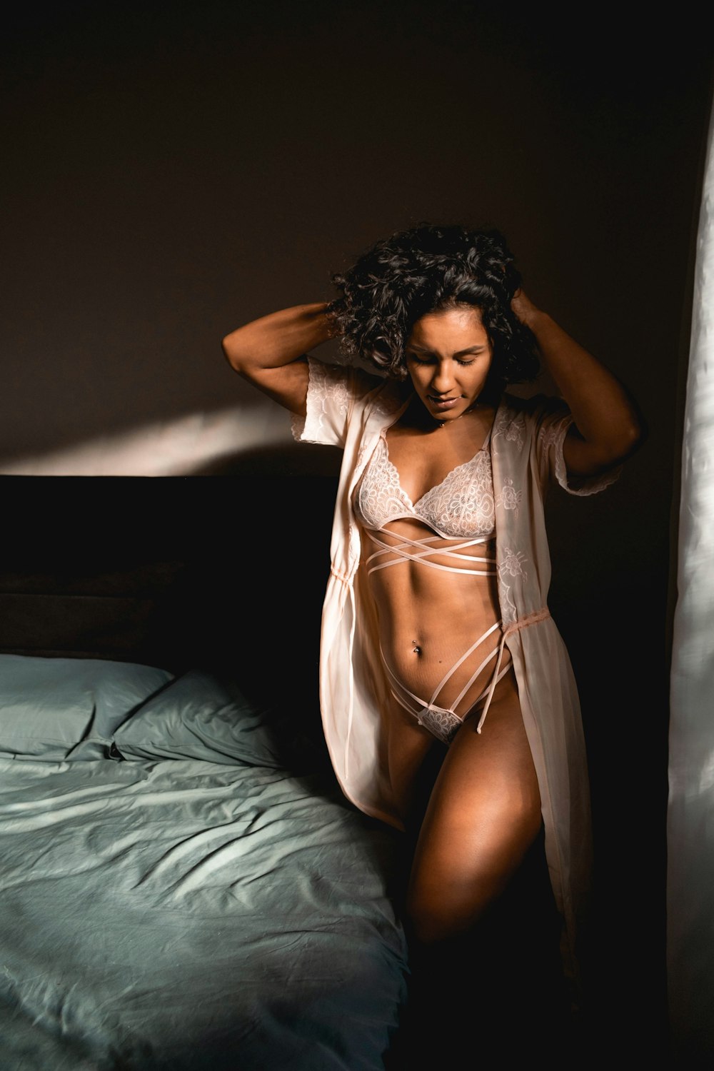 a woman in lingerie posing on a bed
