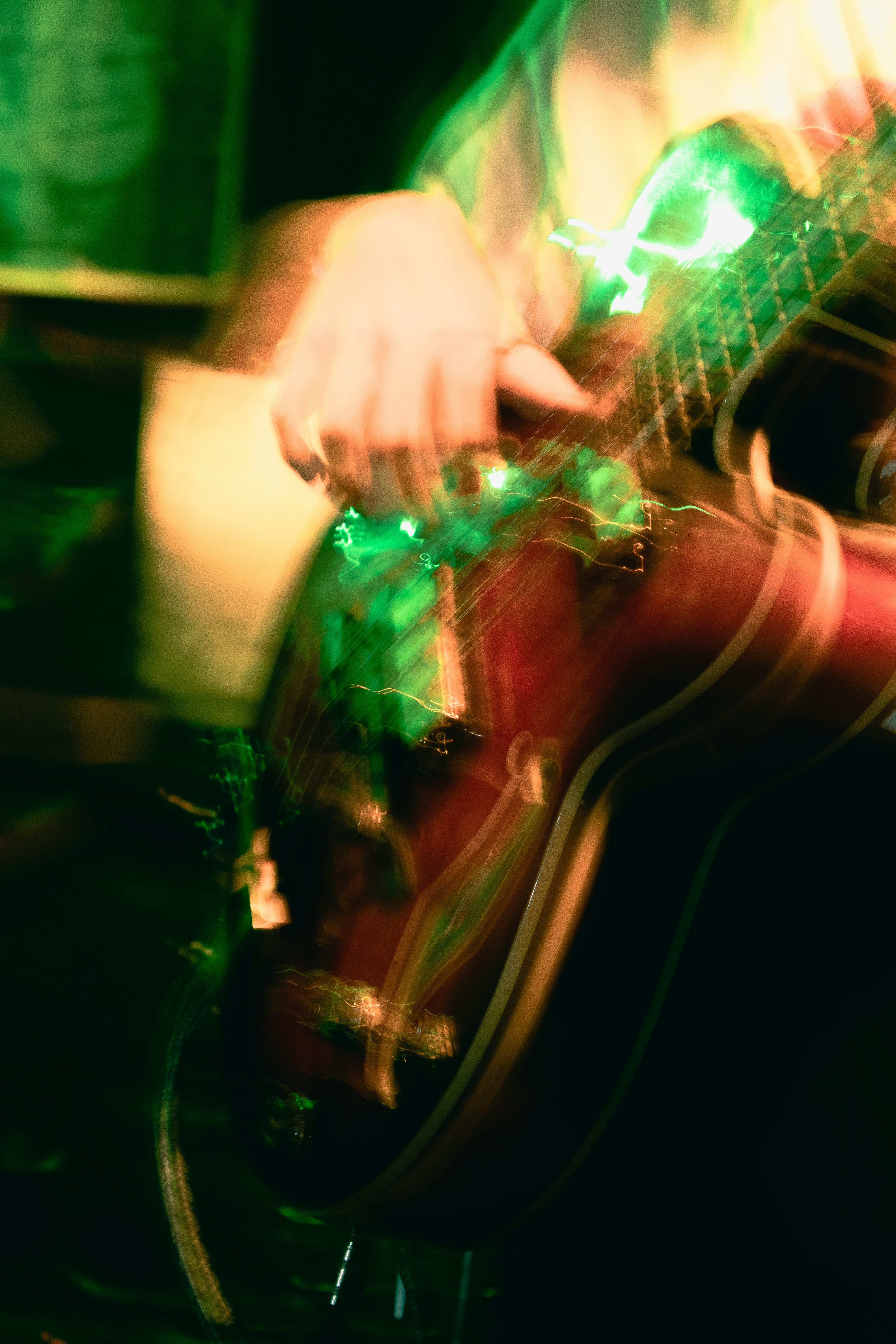 a blurry photo of a person playing a guitar